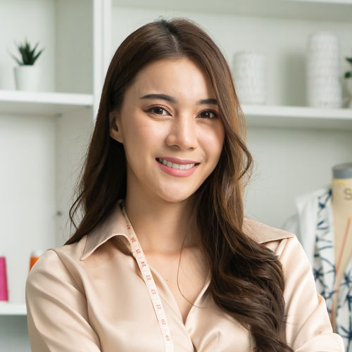 portrait-of-asian-tailor-woman-working-on-clothes
