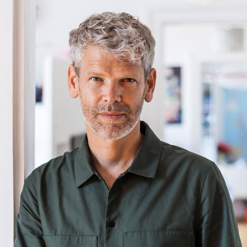 portrait-of-mature-man-with-grey-hair-and-stubble